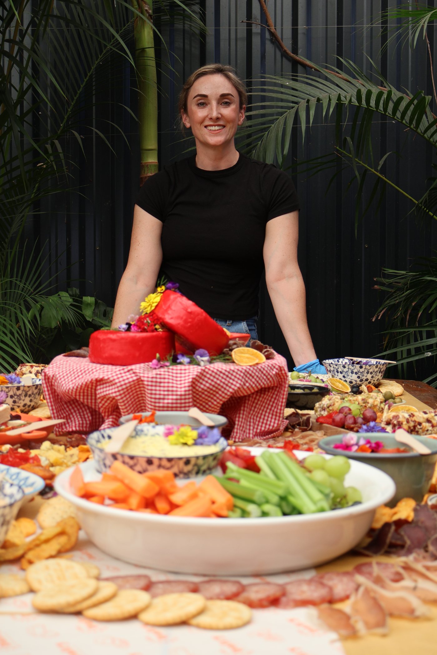 Crafted Dairy's cheesemaker behind a fully dressed grazing table